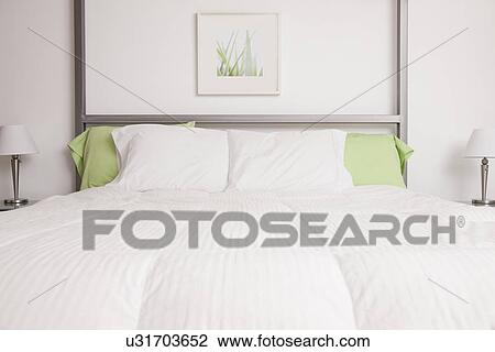 Stock Image - USA, Illinois, Metamora, white and green bedroom. Fotosearch