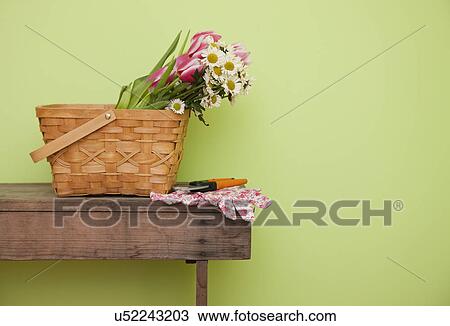 Stock Image - USA, Illinois, Metamora, Wildflowers in basket on table. Fotosearch