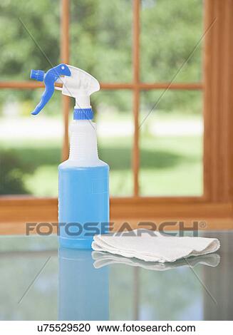 Stock Image - USA, Illinois, Metamora, windshield wiper fluid and rag on table. Fotosearch