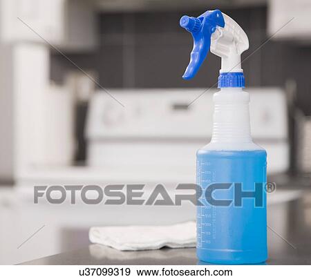Stock Photo - USA, Illinois, Metamora, windshield wiper fluid and rag on kitchen counter. Fotosearch