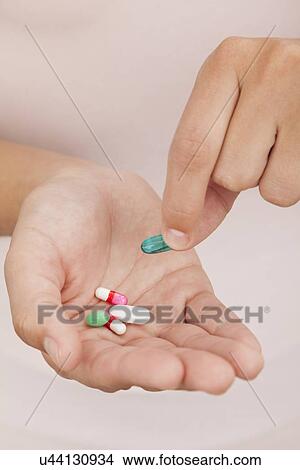 Picture - USA, Illinois, Metamora, Woman holding medicines. Fotosearch
