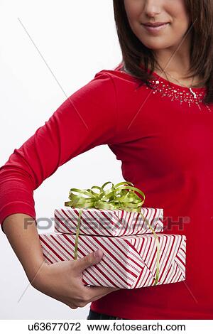 Stock Image - USA, Illinois, Metamora, Woman holding gifts. Fotosearch