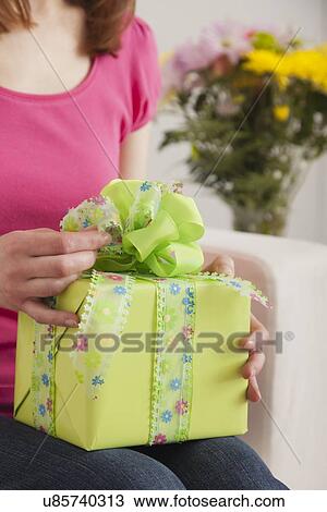 Stock Image - USA, Illinois, Metamora, Woman holding gift. Fotosearch