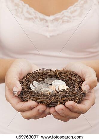 USA, Illinois, Metamora, Woman holding coins in bird's nest View Large Photo Image Stock Photo - USA, Illinois, Metamora, Woman holding coins in bird's nest. Fotosearch