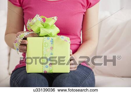 USA, Illinois, Metamora, Woman holding gift View Large Photo Image Stock Photograph - USA, Illinois, Metamora, Woman holding gift. Fotosearch