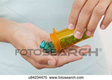 USA, Illinois, Metamora, Woman holding medicines View Large Photo Image Stock Photography - USA, Illinois, Metamora, Woman holding medicines. Fotosearch