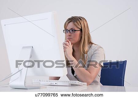 USA, Illinois, Metamora, woman in office sitting at computer View Large Photo Image Stock Photography - USA, Illinois, Metamora, woman in office sitting at computer. Fotosearch