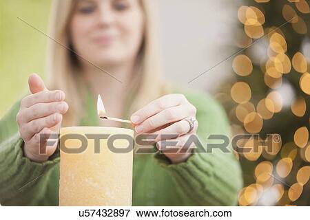 USA, Illinois, Metamora, Woman lighting candle View Large Photo Image Stock Photo - USA, Illinois, Metamora, Woman lighting candle. Fotosearch