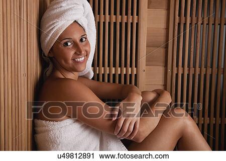 Stock Image - USA, Illinois, Metamora, woman relaxing in sauna. Fotosearch