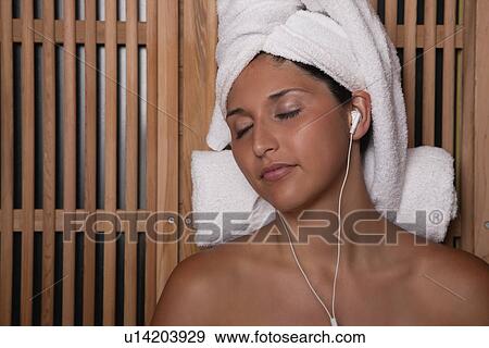 Stock Photo - USA, Illinois, Metamora, woman relaxing in sauna. Fotosearch