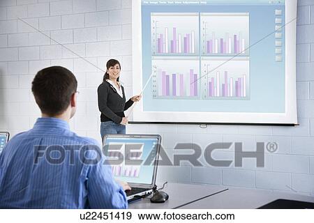Stock Photo - USA, Illinois, Metamora, Woman teaching adult computer class. Fotosearch