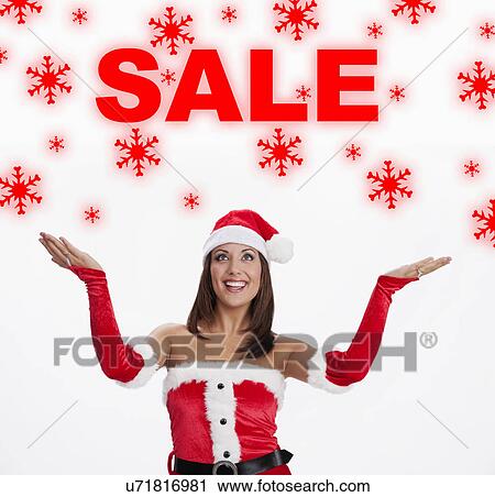 USA, Illinois, Metamora, Woman wearing Santa costume looking at sale sign View Large Photo Image Stock Image - USA, Illinois, Metamora, Woman wearing Santa costume looking at sale sign. Fotosearch