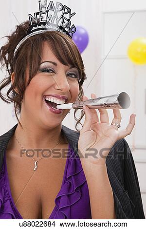 USA, Illinois, Metamora, Woman with noisemaker at New Year's Eve party View Large Photo Image Picture - USA, Illinois, Metamora, Woman with noisemaker at New Year's Eve party. Fotosearch