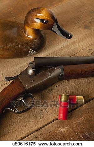 USA, Illinois, Metamora, Wooden duck, gun and bullets on table View Large Photo Image Stock Photography - USA, Illinois, Metamora, Wooden duck, gun and bullets on table. Fotosearch
