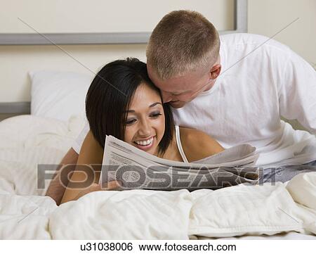 USA, Illinois, Metamora, Young couple in bed View Large Photo Image Stock Photograph - USA, Illinois, Metamora, Young couple in bed. Fotosearch