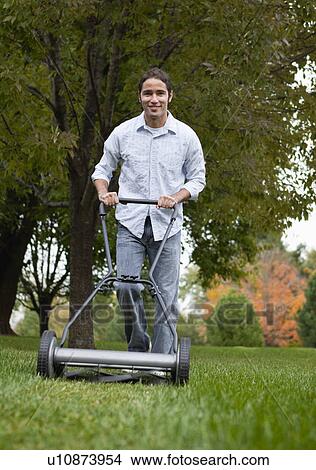 USA, Illinois, Metamora, Young man mowing View Large Photo Image Picture - USA, Illinois, Metamora, Young man mowing. Fotosearch