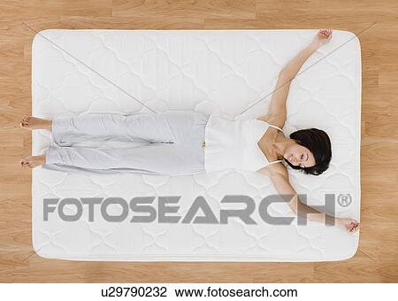 USA, Illinois, Metamora, Young woman lying on mattress and smiling View Large Photo Image Stock Image - USA, Illinois, Metamora, Young woman lying on mattress and smiling. Fotosearch