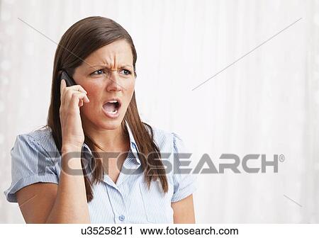 USA, Illinois, Metamora, young woman shouting into mobile phone View Large Photo Image Stock Image - USA, Illinois, Metamora, young woman shouting into mobile phone. Fotosearch