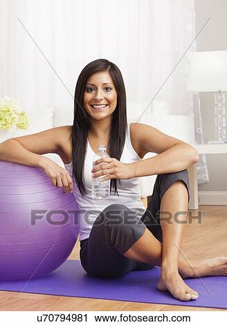 Stock Image - USA, Illinois, Metamora, Young woman with exercise ball . Fotosearch