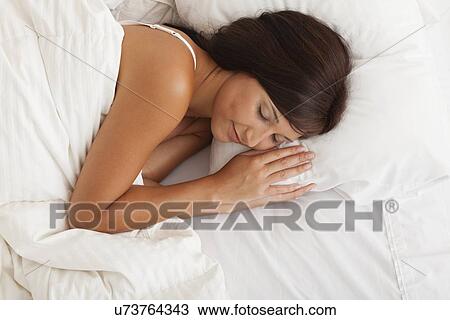 USA, Illinois, Metamora, young woman sleeping in bed View Large Photo Image Stock Image - USA, Illinois, Metamora, young woman sleeping in bed. Fotosearch