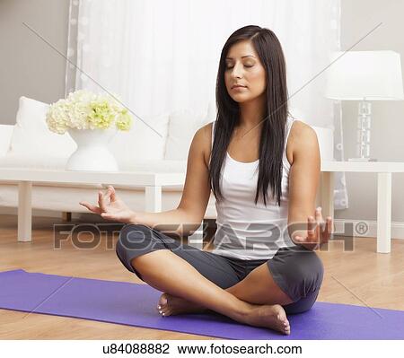 USA, Illinois, Metamora, Young woman meditating View Large Photo Image Stock Image - USA, Illinois, Metamora, Young woman meditating. Fotosearch