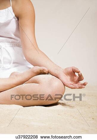 USA, Illinois, Metamora, Young woman doing yoga on beach View Large Photo Image Stock Photo - USA, Illinois, Metamora, Young woman doing yoga on beach. Fotosearch