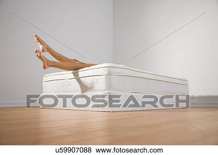 USA, Illinois, Metamora, Young woman lying on mattress View Large Photo Image Stock Photo - USA, Illinois, Metamora, Young woman lying on mattress. Fotosearch