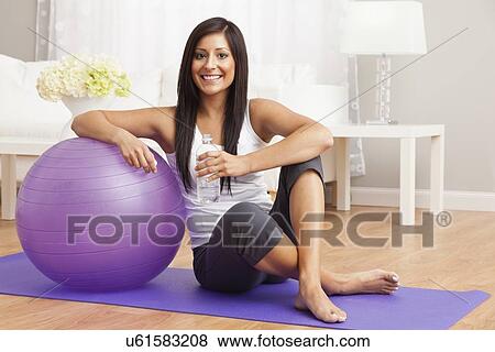 USA, Illinois, Metamora, Young woman with exercise ball View Large Photo Image Stock Photo - USA, Illinois, Metamora, Young woman with exercise ball . Fotosearch