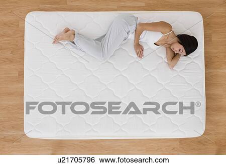 USA, Illinois, Metamora, Young woman sleeping on mattress View Large Photo Image Stock Photograph - USA, Illinois, Metamora, Young woman sleeping on mattress. Fotosearch