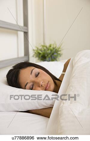 USA, Illinois, Metamora, Young woman asleep in bed View Large Photo Image Stock Photograph - USA, Illinois, Metamora, Young woman asleep in bed. Fotosearch