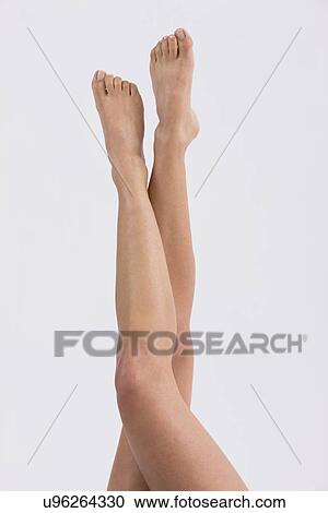 Stock Image - USA, Illinois, Metamora, Young woman's legs on white background. Fotosearch