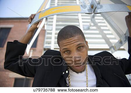 USA, Illinois, Peoria, Portrait of young man outdoors View Large Photo Image Stock Photo - USA, Illinois, Peoria, Portrait of young man outdoors. Fotosearch