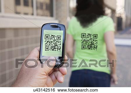 Stock Photograph - USA, Illinois, Peoria, Sample of using smart phone device. Fotosearch