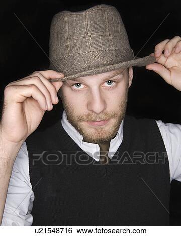 USA, Illinois, Peoria, Studio portrait of young man wearing hat View Large Photo Image Stock Photograph - USA, Illinois, Peoria, Studio portrait of young man wearing hat. Fotosearch