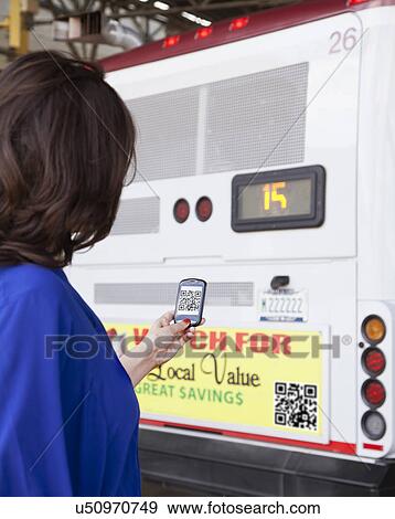 Stock Photo - USA, Illinois, Peoria, Woman using smart phone device. Fotosearch