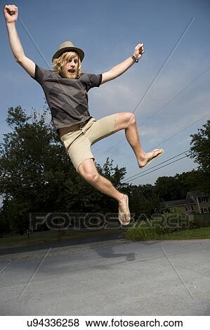 USA, Illinois, Peoria, Young man jumping and cheering View Large Photo Image Stock Photo - USA, Illinois, Peoria, Young man jumping and cheering. Fotosearch