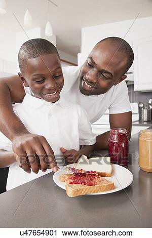 USA, Metamora, Illinois, Father preparing jam sandwich to his son (6-7) View Large Photo Image Stock Image - USA, Metamora, Illinois, Father preparing jam sandwich to his son (6-7). Fotosearch