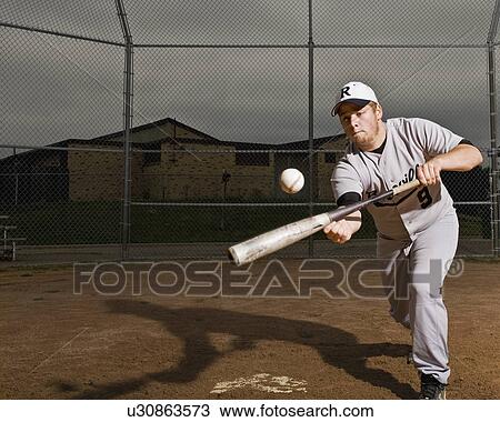 Stock Image - USA, Minnesota, Roseville, young man playing baseball. Fotosearch