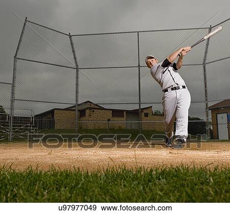 USA, Minnesota, Roseville, young man playing baseball View Large Photo Image Stock Photo - USA, Minnesota, Roseville, young man playing baseball. Fotosearch