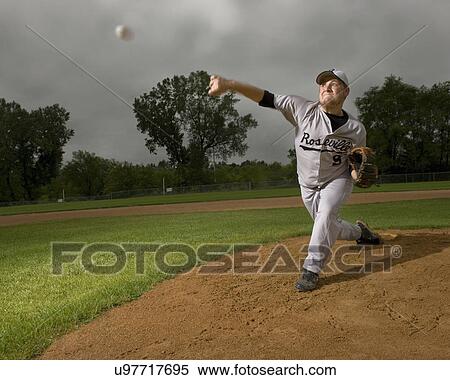 Stock Photography - USA, Minnesota, Roseville, young man playing baseball. Fotosearch