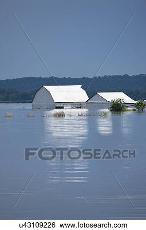 Stock Photograph - USA, Missouri, Barn and house in flood. Fotosearch