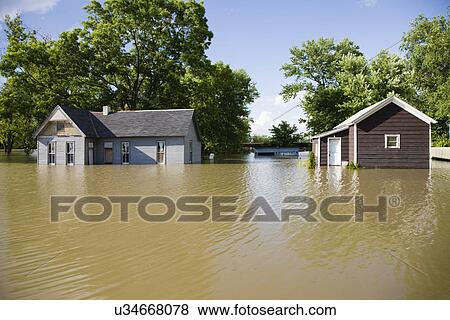 Stock Photo - USA, Missouri, Cottage houses in flood. Fotosearch