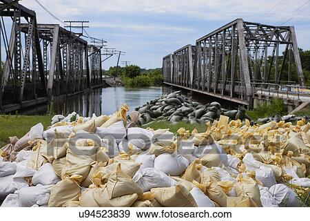USA, Missouri, Flood sandbags near river and bridges View Large Photo Image Stock Photo - USA, Missouri, Flood sandbags near river and bridges. Fotosearch