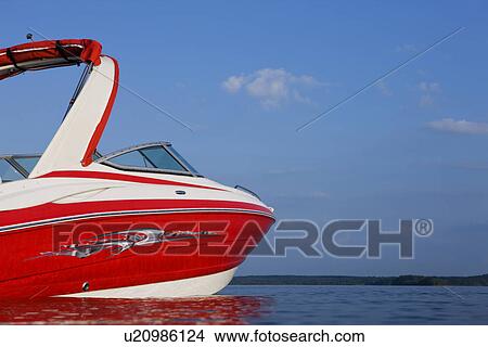 Picture - USA, Missouri, Stockton, Stockton Lake, red motorboat on lake. Fotosearch