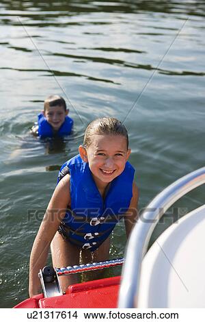 Picture - USA, Missouri, Stockton, Stockton Lake, boy (6-7) and girl (8-9) swimming in lake. Fotosearch