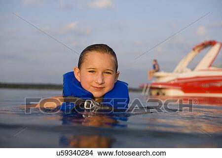 Picture - USA, Missouri, Stockton, Stockton Lake, girl (8-9) swimming in lake. Fotosearch