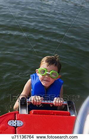 Picture - USA, Missouri, Stockton, Stockton Lake, boy (6-7) swimming in lake. Fotosearch