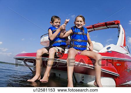 USA, Missouri, Stockton, Stockton Lake, boy (6-7) and girl (8-9) sitting on boat View Large Photo Image Stock Image - USA, Missouri, Stockton, Stockton Lake, boy (6-7) and girl (8-9) sitting on boat. Fotosearch