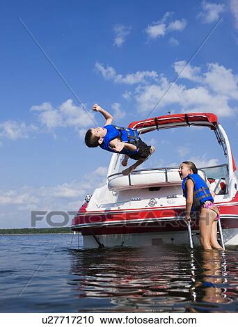 USA, Missouri, Stockton, Stockton Lake, boy (6-7) and girl (8-9) playing on boat View Large Photo Image Stock Image - USA, Missouri, Stockton, Stockton Lake, boy (6-7) and girl (8-9) playing on boat. Fotosearch