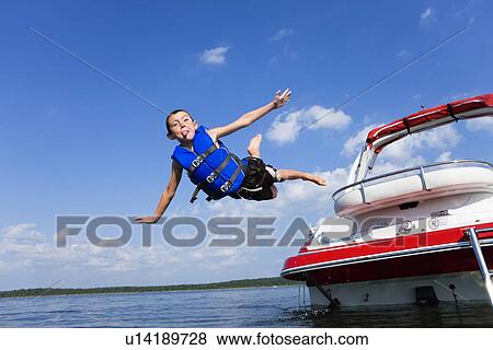 USA, Missouri, Stockton, Stockton Lake, boy (6-7) jumping off boat View Large Photo Image Stock Photo - USA, Missouri, Stockton, Stockton Lake, boy (6-7) jumping off boat. Fotosearch